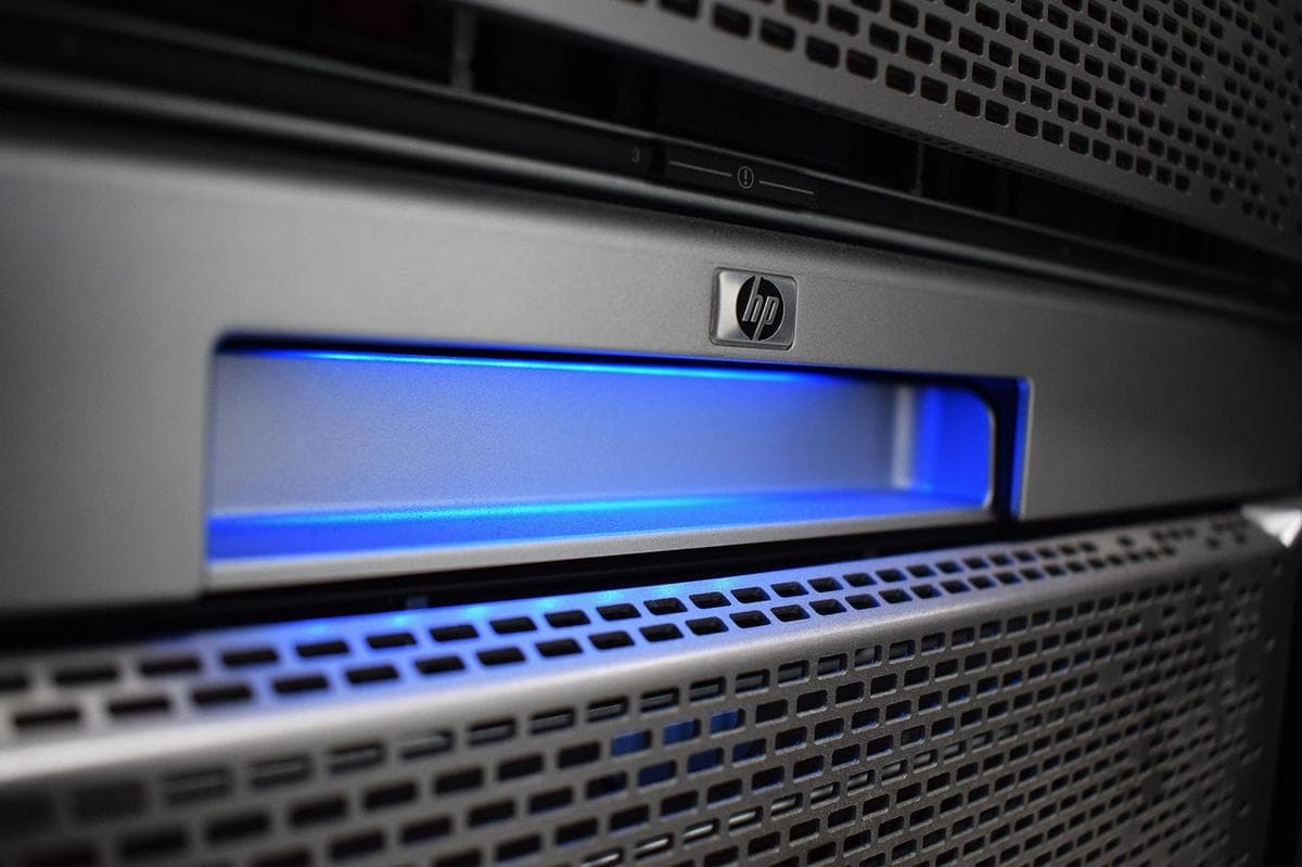 Grande plano de um servidor de rack HP com painel frontal iluminado a azul num centro de dados