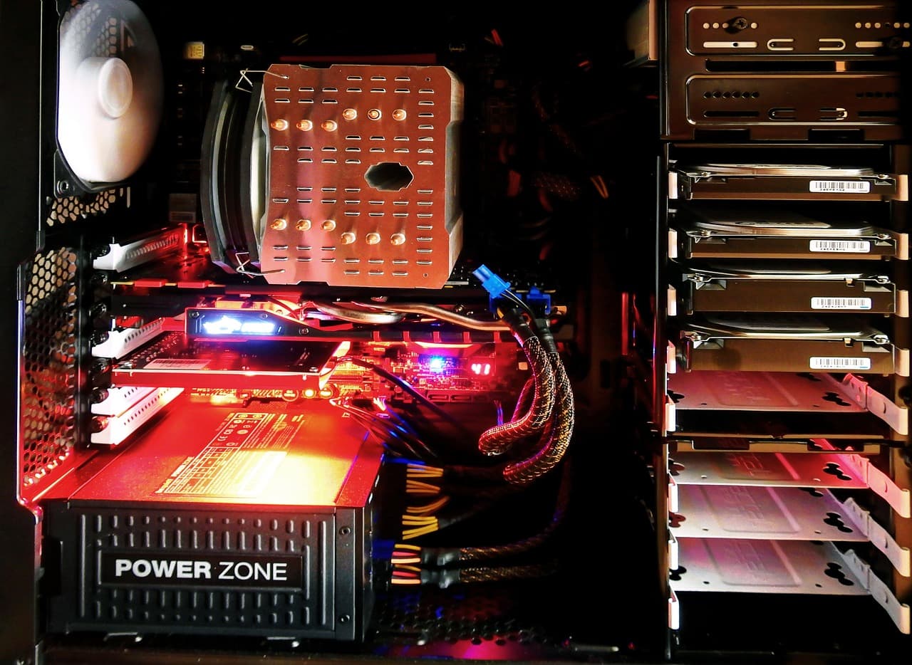 Inside a desktop PC case with several drives and a power supply — a typical home-server build for self-hosting.